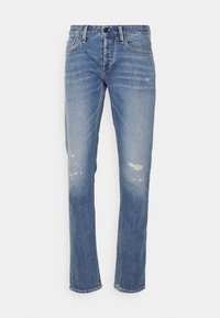 Modré džíny z denimu s úzkým střihem, s opotřebovanými oblastmi a vyblednutím. Standardní pas s poutky na opasek a design s pěti kapsami.