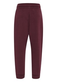 Bordeauxfarbene Jogginghose aus weichem, elastischem Material, mit elastischem Bund und schmal zulaufenden Säumen. Einfaches Design ohne sichtbare Muster oder Akzente.