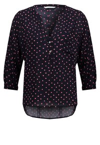 Blouse bleu marine foncé à manches trois quarts, avec un col en V, des boutons sur le devant et un motif à pois roses.