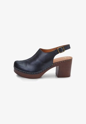 Black leather clog with an open back, adjustable strap, and a chunky wooden heel. Features a smooth texture and visible stitching accents.