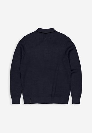 Navy blue knit cardigan with a ribbed texture, collared neckline, and long sleeves. Features a subtle hem detail and logo tag at the bottom.