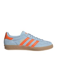 Blue suede sneaker with orange accents and three stripes, featuring a gum rubber sole and textured tongue, labeled "Gazelle" and "adidas."