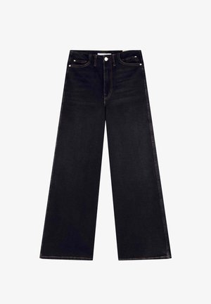 Bredde ben jeans lavet af mørk denim, med høj talje, to forlommer, en knaplukning og kontrasterende gule syninger.