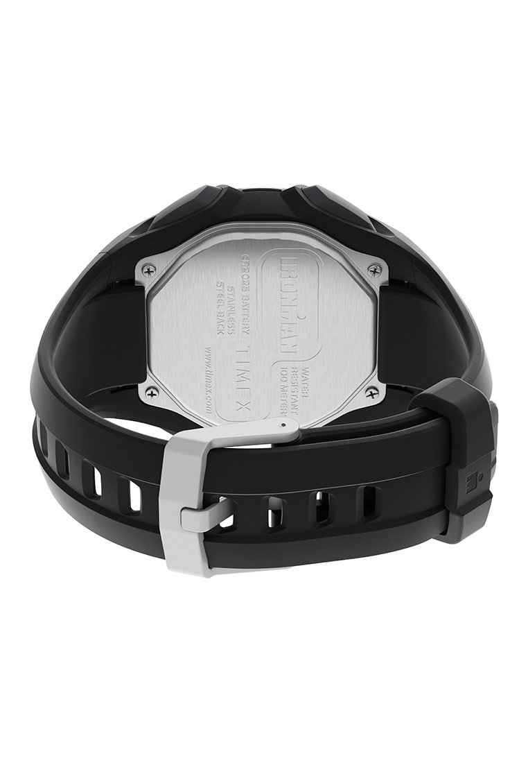 Reloj con correa de silicona negra y fondo octagonal de acero inoxidable, hebilla plateada y detalles de la marca grabados. Presenta agujeros de ventilación.