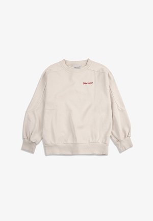 Felpa beige a maniche lunghe con scollo rotondo, polsini e orlo a coste, con piccolo testo rosso "Bobo Choses" sul petto a sinistra.