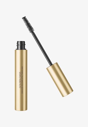 Tube de mascara doré avec une brosse à poils noirs déployée, étiquetée "Golden Oasis Endless Volume Effect Mascara" sur fond blanc.
