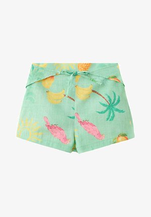 Short vert clair avec imprimé tropical mettant en scène des perroquets roses, des bananes, des ananas, des palmiers et des soleils jaunes, noué avec un nœud devant.