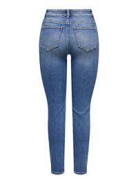 Jean skinny bleu taille haute avec poches arrière, décoloration subtile sur les cuisses et les coutures, présenté sur un fond blanc.