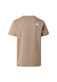 Beige tričko s krátkým rukávem se malým bílým logem "The North Face" na horní části zad a černou značkovou etiketou na spodním lemu.
