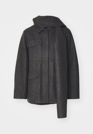 Tamsiai pilkas vilnonis paltas su aukštu apykakle, dviem priekinėmis kišenėmis ir tvarkingu, struktūruotu siluetu. Paltas pasižymi tekstūruotu audiniu ir minimalistiniu dizainu.