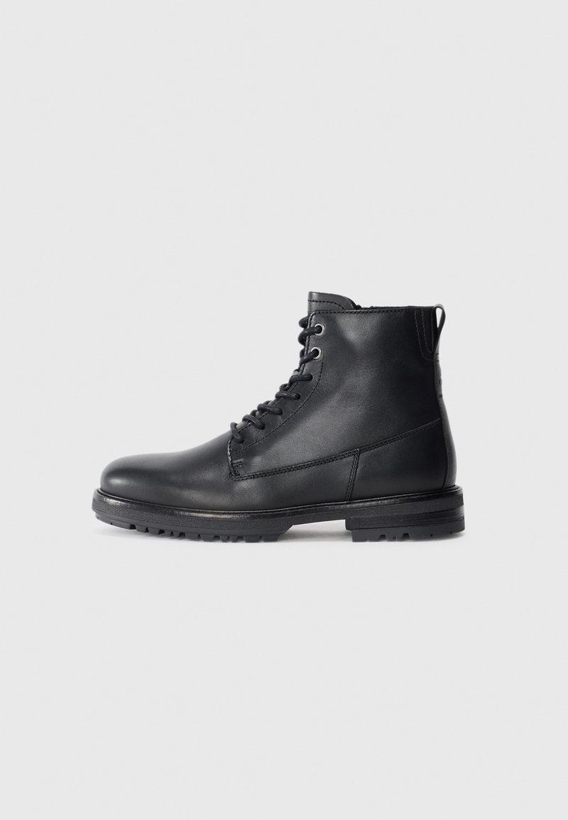 Black leather ankle boots with lace-up front, rounded toe, and rugged sole. Smooth texture with minimal stitching detail and pull tab.