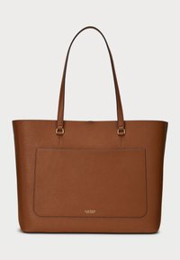 Brown faux leather tote bag with two long handles, a textured surface, and a front pocket. Features gold-tone hardware and logo detail.