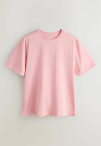 T-shirt en coton rose clair uni à manches courtes et col rond, présenté sur fond neutre.
