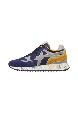 Retro-style sneaker with blue, gray, and mustard suede panels, black laces, star design on side, and patterned white sole.