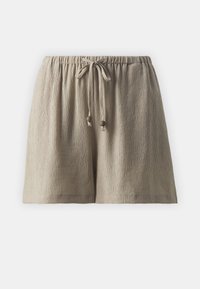Shorts beige clair texturés avec une taille élastique et fermeture par cordon. Présentent des perles décoratives aux extrémités du cordon.