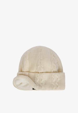 Cream knit beanie with cable pattern and folded brim, showing soft inner lining on one side.