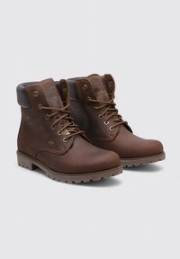 Bottines en cuir marron avec œillets en métal, bout rond, col rembourré, semelle en caoutchouc et détail de logo embossé sur le côté.