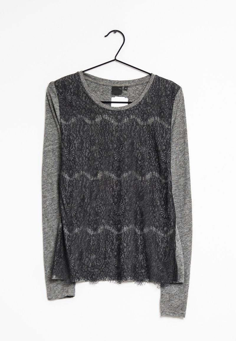 Top a maniche lunghe con davanti in pizzo nero e maniche in jersey grigio. Collo tondo e spacchi laterali all'orlo per un tocco di stile.