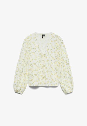 Blusa bianca a maniche lunghe con stampa floreale gialla, scollo a V, chiusura con bottoni sul davanti e polsini elasticizzati.