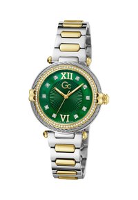 Ümmargune kell, millel on roheline tekstureeritud kelladial, kuldsed aktsendid, teemantmärgid ja kahetooniline hõbe-kuldne metallrihm.