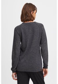 Dark gray sweatshirt with a textured finish, long raglan sleeves, and a slightly relaxed fit. Features a small brown leather logo tag at the hem.