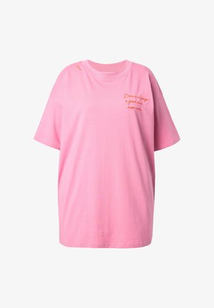 Růžové oversize bavlněné tričko s krátkými rukávy, se dvěma oranžovými vyšitými nápisy a malými dekorativními detaily na rameni.