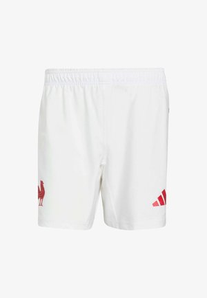 Pantaloncini bianchi con vita elastica, con un emblema di un gallo rosso e strisce Adidas rosse ai lati. Tessuto dalla texture liscia.