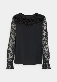 Haut noir à manches longues avec un corps uni et une dentelle noire complexe sur les manches, avec des poignets évasés en dentelle et un col rond.