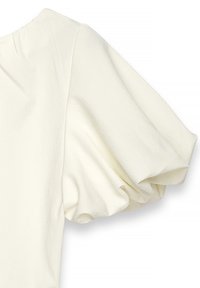 Top bianco con maniche a sbuffo realizzato in un tessuto morbido, con scollatura rotonda e dettagli strutturati sulle spalle. Il design mette in risalto il volume delle maniche.