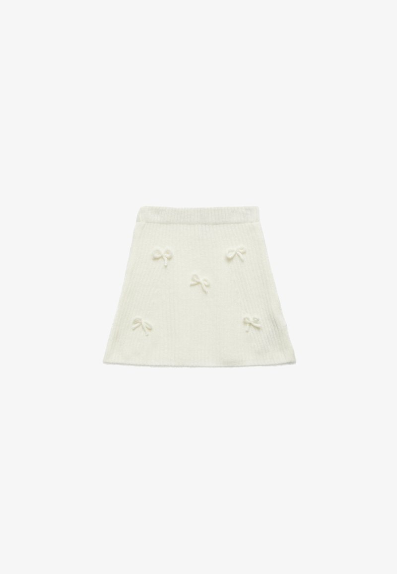 White knitted skirt with a flared shape, featuring raised bow accents and a ribbed texture. Simple waistband for easy wear.
