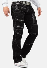 Pantaloni in denim neri con cuciture bianche, multiple tasche e dettagli ricamati. Caratterizzati da un design a gamba dritta e una vita sicura.