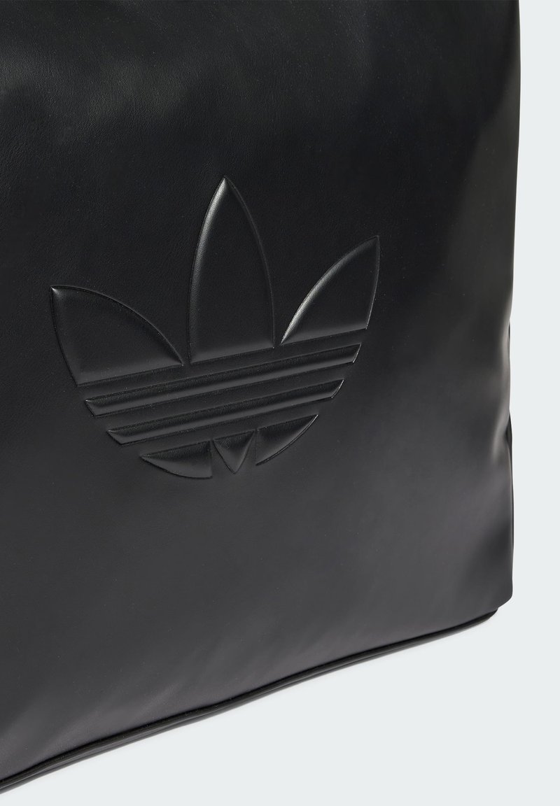 Schwarze Lederhandtasche mit geprägtem Drei-Blatt-Logo und horizontalen Streifen. Glatte Textur mit abgerundeten Kanten. Schlichtes, modernes Design.