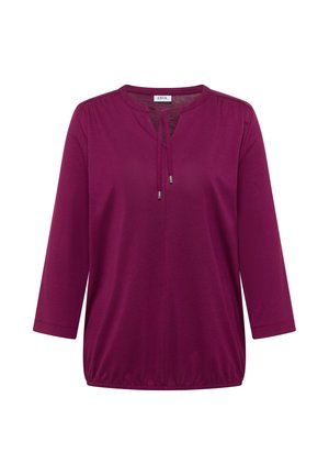 Fialový tunikový top s kulatým výstřihem, tříčtvrtečními rukávy, nastavitelným šňůrkovým zavazováním u výstřihu a volným řaseným lemem.