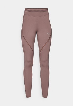 Bruine hoge taille leggings van rekbare stof, met geometrische naadpatronen en een klein logo aan de linkerkant.
