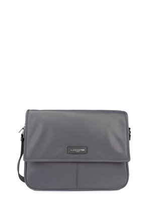 Grey nylon messenger bag with a front flap, zip closure, and adjustable strap. Features a black logo plate on the front. Smooth texture.