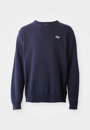 Navyblauwe gebreide ronde hals trui met geribde boorden en zoom. Heeft een klein logo op de borst en een zachte textuur.