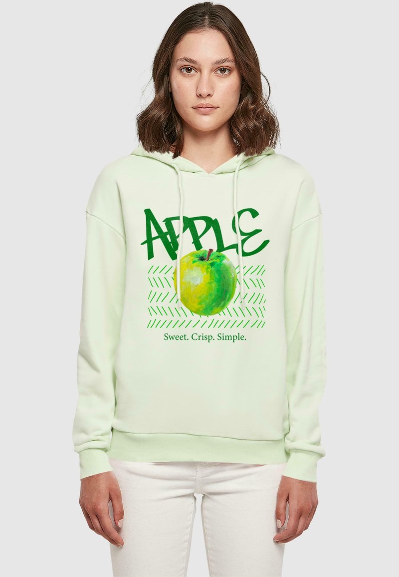 Felpa verde chiaro con un grafico di una mela verde e la parola "APPLE" in grassetto verde, accompagnata dalla frase "Dolce. Croccante. Semplice."