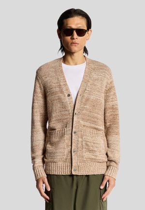 Beige stickad cardigan med ett texturerat mönster, v-ringning, fem knappar och ribbade ärm- och nederkanter. Har två framfickor.
