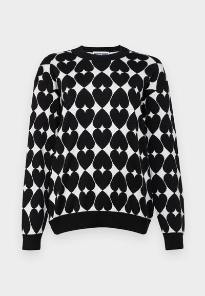 Black and white sweater featuring a heart pattern, ribbed crew neck and cuffs, with a textured knit finish.