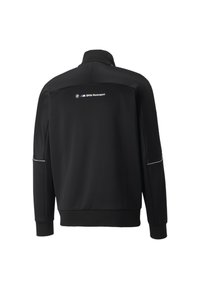 Veste noire avec col haut et manches longues. Présente le logo BMW Motorsport en blanc au dos, des accents réfléchissants discrets et une texture lisse.