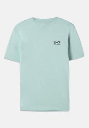 Light mint green t-shirt made of cotton, featuring short sleeves and a round neck, with a small black EA7 logo on the chest.