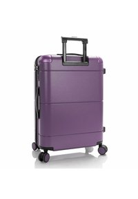 Valigia rigida viola con finitura testurizzata, manico nero retrattile e quattro ruote per mobilità.