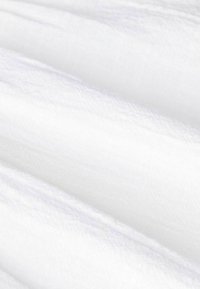White cotton fabric with a soft, smooth texture, featuring subtle draping and slight sheen, reflecting light gently across the surface.