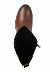 Botte cheville en cuir marron avec une texture lisse, bout arrondi, doublure intérieure visible et détail de fermeture éclair sur le côté.