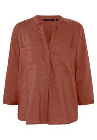 Chemise en lin couleur rouille avec col mandarin, patte sans boutons et deux poches avant. Manche trois-quarts et coupe décontractée.