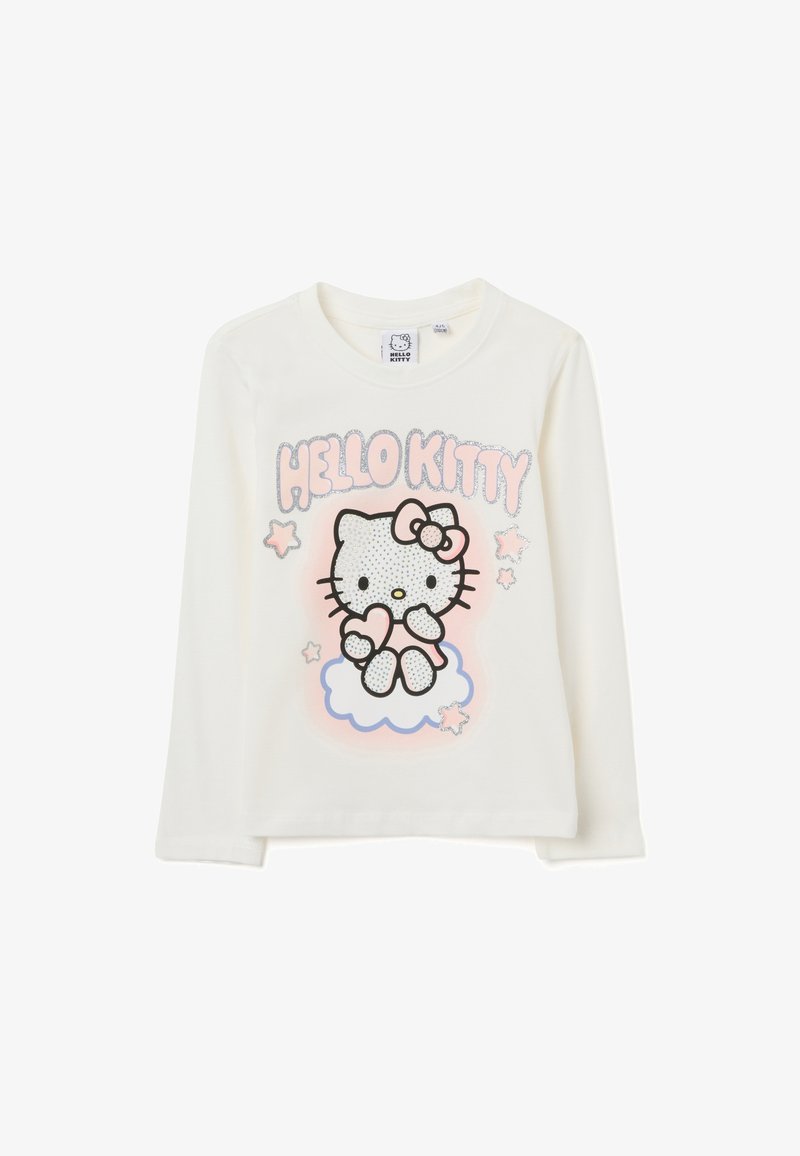 Langärmliges cremefarbenes Shirt mit einem glitzernden, gepunkteten Hello Kitty-Graphic, rosa Akzenten und Sternenmotiven auf einem hellblauen Wolkenhintergrund.