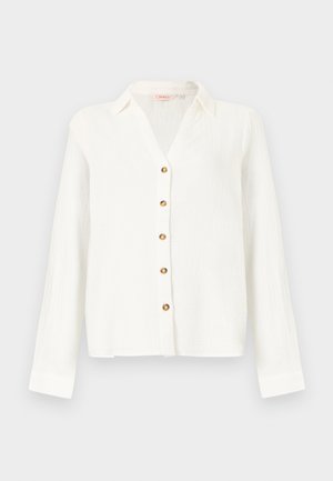 Blusa bianca a maniche lunghe con colletto e cinque bottoni marroni sulla parte anteriore, realizzata in tessuto leggero e strutturato.