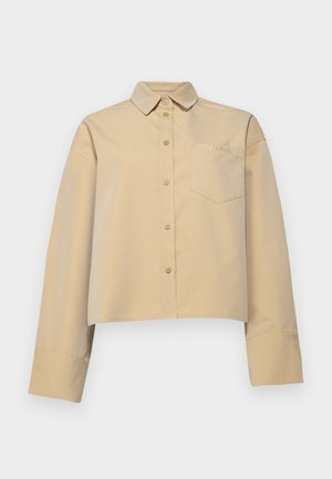 Beige gekürztes Shirt aus Baumwollmischung, mit spitzem Kragen, Knopfleiste und einer kleinen Brusttasche mit Logo-Stickerei.
