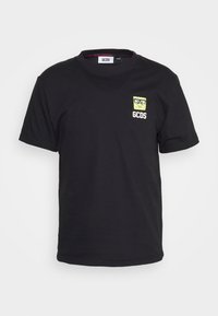 Černé bavlněné tričko s krátkým rukávem, se malou žlutou grafikou SpongeBoba a textem "GCDS" na levé části hrudi.