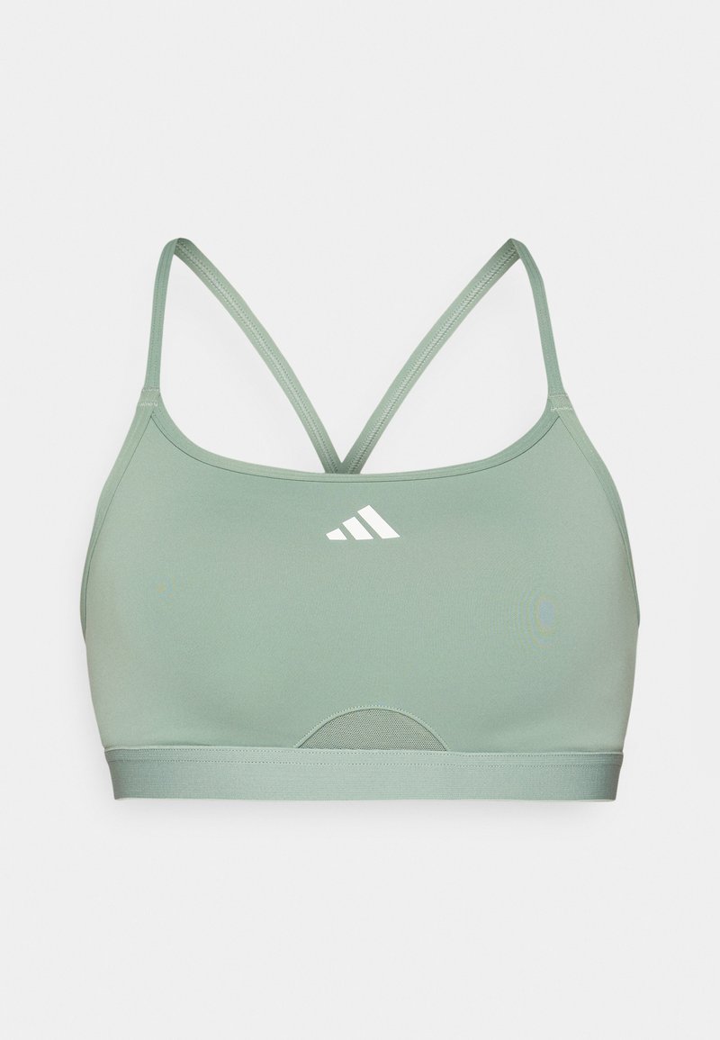 Top sportivo verde con sottili spalline incrociate, un pannello in rete nella parte inferiore e un piccolo logo bianco sul davanti per il branding.
